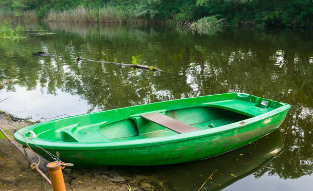 istock small oar boat near a quiet river coast 1300701221