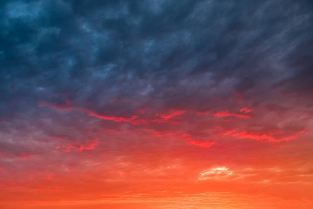 istock Colorful and dramatic sunset with red tinted clouds. Sky Background or texture 1300701284