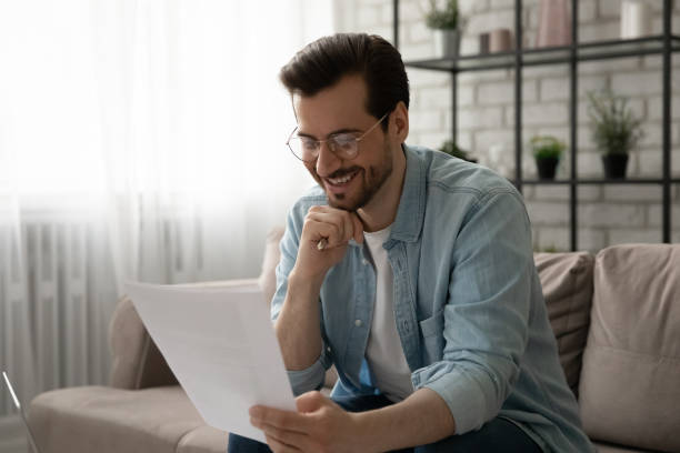 istock Smiling businessman holding profitable contract hardcopy enjoying perfect work result 1300701488