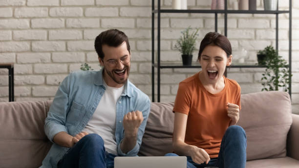 istock Happy young spouses getting email with loan approval from bank 1300701491