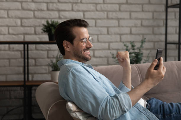istock Young man lying on couch shooting cute selfie on smartphone 1300701501