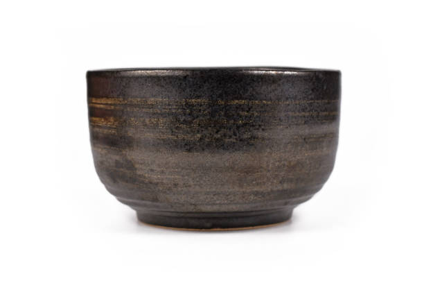 istock Dark black and brown unglaced ceramic bowl 1300702399