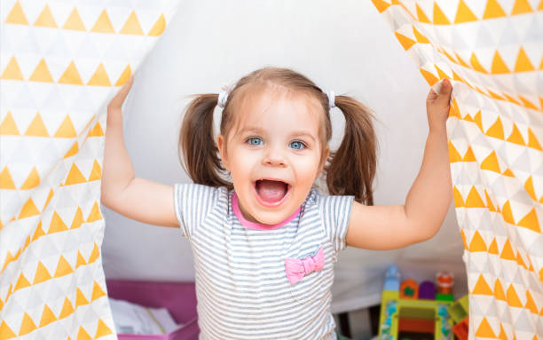 istock Delighted child laughing at home 1300704343
