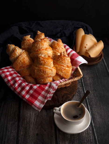 Hot croissants with cheese with a cup of hot coffee. French pastries.