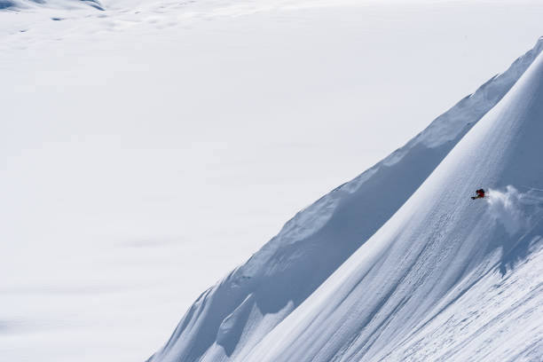istock Backcountry skier descends snow slope in mountains 1300706019