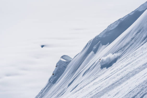 istock Backcountry skier descends snow slope in mountains 1300706607