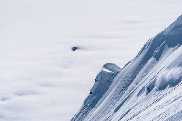 istock Backcountry skier descends snow slope in mountains 1300706612