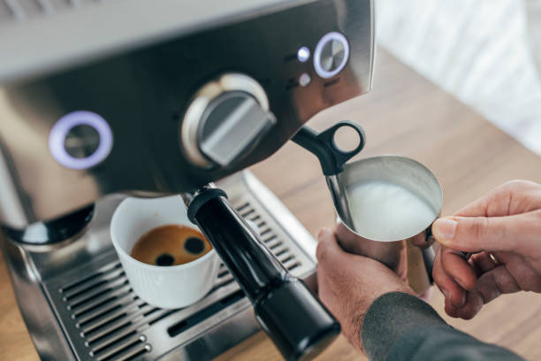 Frothing milk on a coffee machine Frothing milk on a coffee machine milk froth stock pictures, royalty-free photos & images