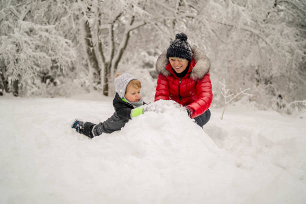 istock Mother and a son spending winter day outside on the snow 1300708055