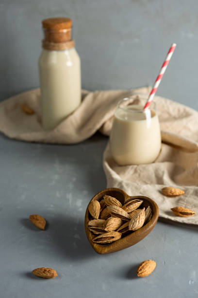 istock Almonds and almond milk on a gray background. 1300710077