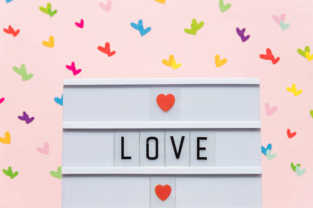 istock Valentine's Day composition with text LOVE and hearts on pink background.Message with red heart and letters i love you ,romance symbol.Web banner. Copy space 1300710134