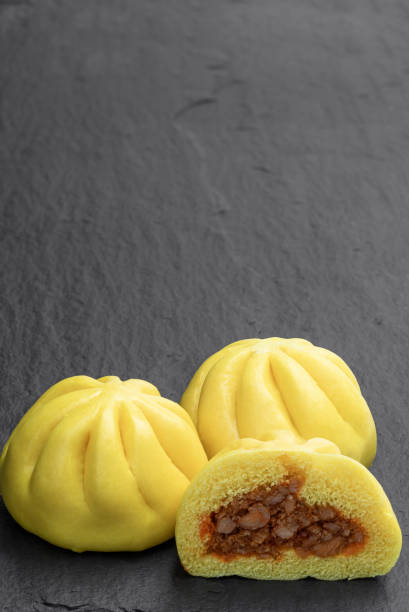 istock Steamed honey chicken and duck bao buns on stone background 1300712430
