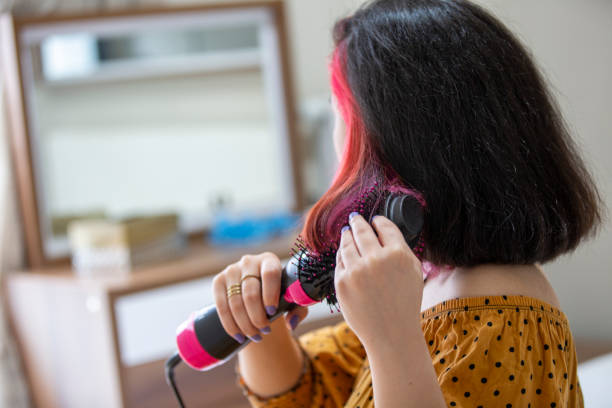 jovem mulher secando cabelo com secador de cabelo - hairbrush - fotografias e filmes do acervo