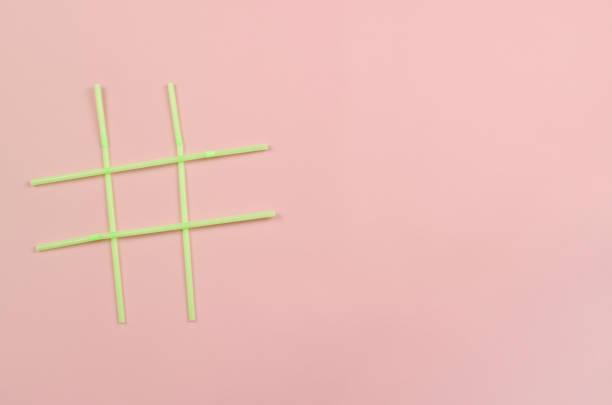 istock Hashtag symbol of green plastic beverage straws on pink background 1300717152