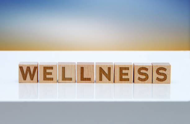 istock 'Wellness' message sign on wooden blocks sitting on a white table. 1300718047
