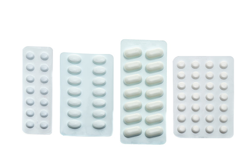 Various white blister packs of pills - white background