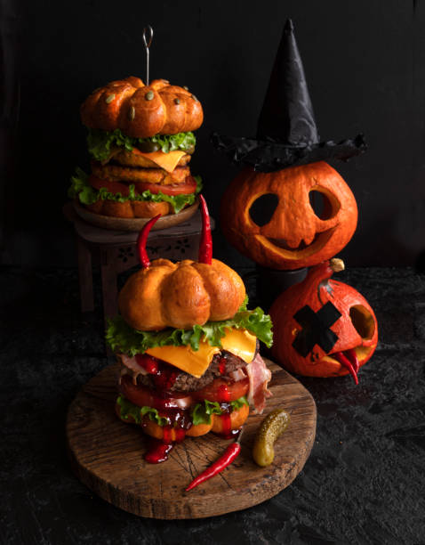 istock Funny pumpkin burger with a big cutlet. Halloween 1300719431