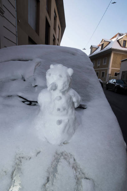 istock a white snowman in winter 1300721297