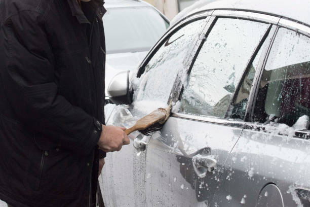 istock removing snow from the car 1300721331