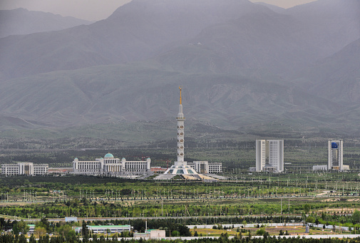 Ashgabat, Turkmenistan: skyline of the Archabil avenue government district - left to right: Agricultural Complex, Congress Palace, Constitution Monument, Statistics Committee, Ministry of Education and Ministry of Foreign Affairs,  in the background the the slopes of the Kopet Dag mountains (also known as the Turkmen-Khorasan Mountain Range, mark the border with Iran)