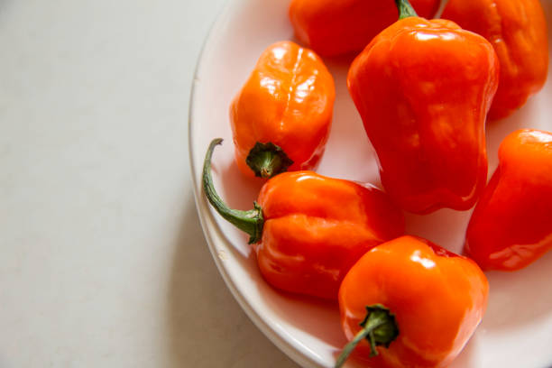 A plate of habanero peppers. Close up and room for copy.