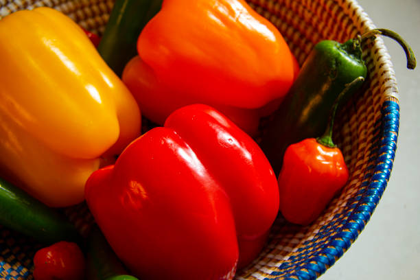 Close up shot of a basket of assorted peppers.