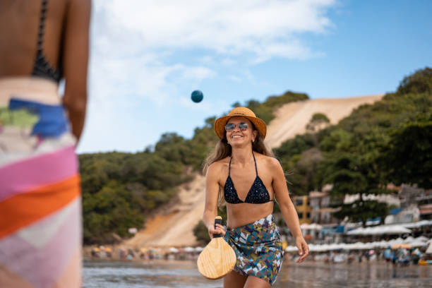 Women playing paddleball on beach Women, Play, Tennis, Rio Grande do Norte, Christmas sarong stock pictures, royalty-free photos & images