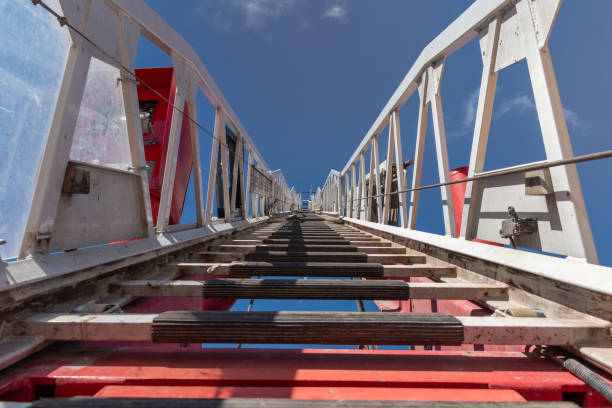 istock Fire truck ladder leading to the sky. 1300738334