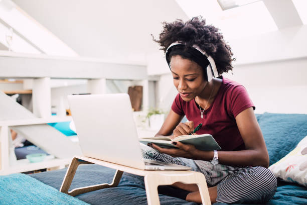 istock Happy African-American working from her bed 1300739109
