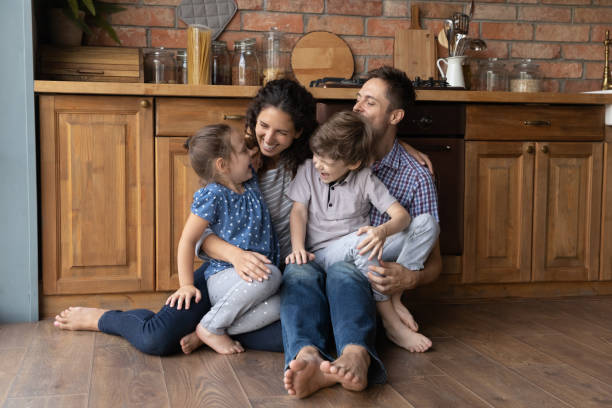 istock Happy parents play at home with two small kids 1300739244