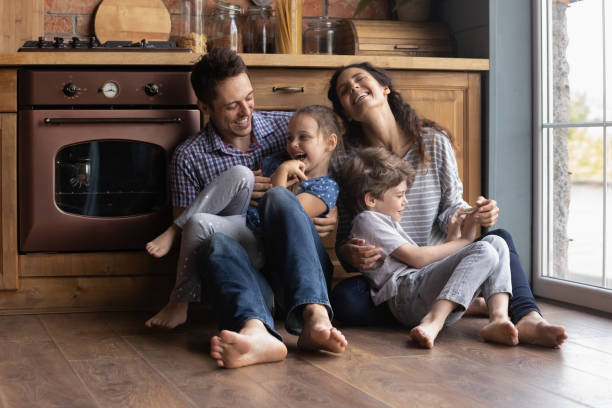 los padres alegres se divierten jugando con los niños pequeños - small domestic kitchen apartment rental fotografías e imágenes de stock