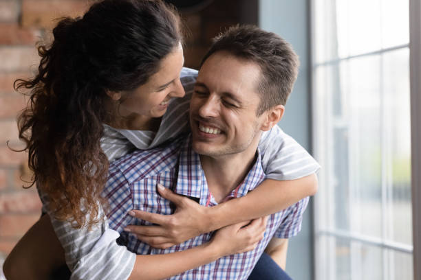 istock Happy couple have fun relaxing at home together 1300739262