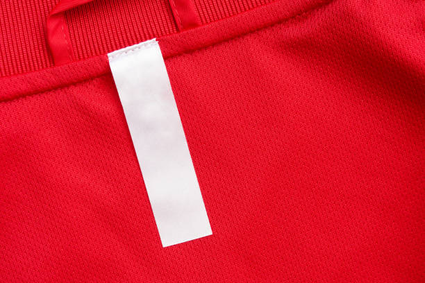 istock White blank clothes label on red jersey texture background 1300739334