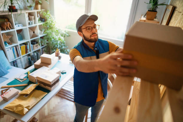 istock The delivery man arranges the parcels on the shelf 1300739347