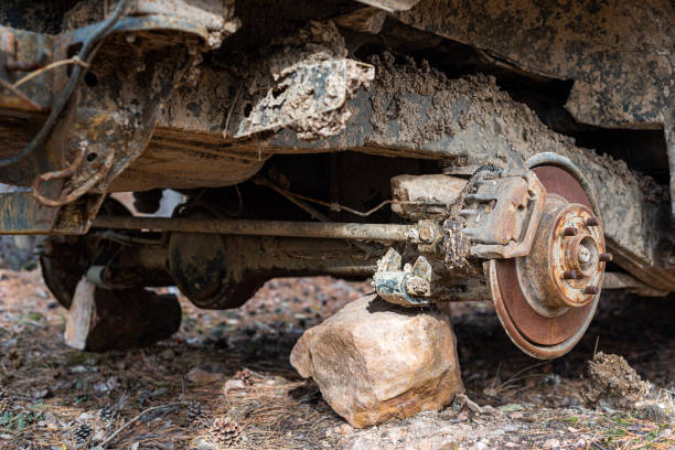 istock Close-up car with missing wheels stolen car wheel pollution and crime problem conversation vintage rusted detail discarded in autumn forest in Bulgaria, Eastern Europe 1300739428
