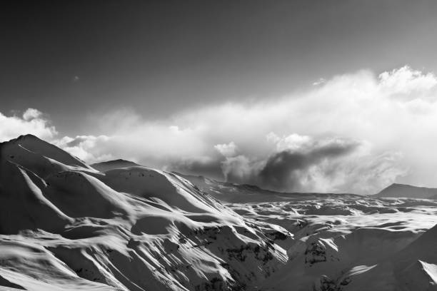 istock Black and white view on evening sunlight mountains in cloud 1300739517