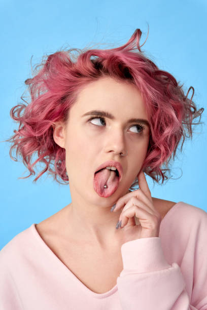 istock Young woman with pink hair looking aside 1300739575