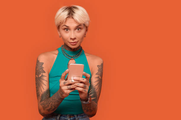 istock Young adult woman using modern smartphone in studio 1300739590