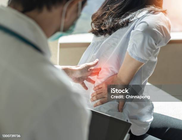 Lower Back Pain Back Ache Muscle Or Spine Injury In Menopause Woman Patient With Backache From Osteoporosis Disease Or Office Syndrome Seeing Orthopedic Surgical Doctor For Medical Treatment Stock Photo - Download Image Now