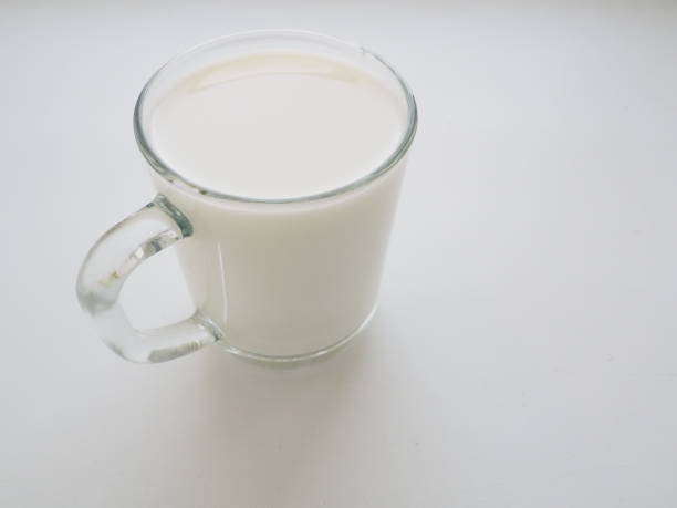 istock Glass cup with milk on a white background. Diet protein food 1300739741