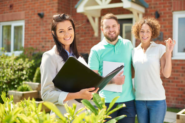 istock real estate agent with house viewers 1300742136