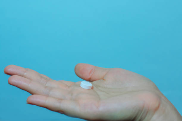 istock White seed medicine on fingers 1300750093