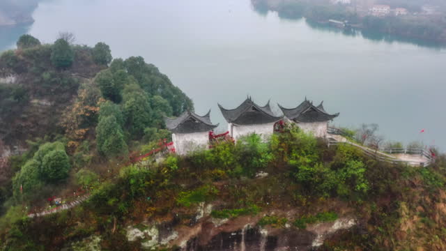 Three Taoist temples stand on the cliff island in the river