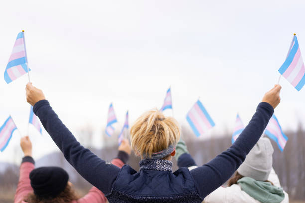 Group of people on a transgender demontration Diverse people on a transgender demonstration holding transgender flags transgender protest stock pictures, royalty-free photos & images