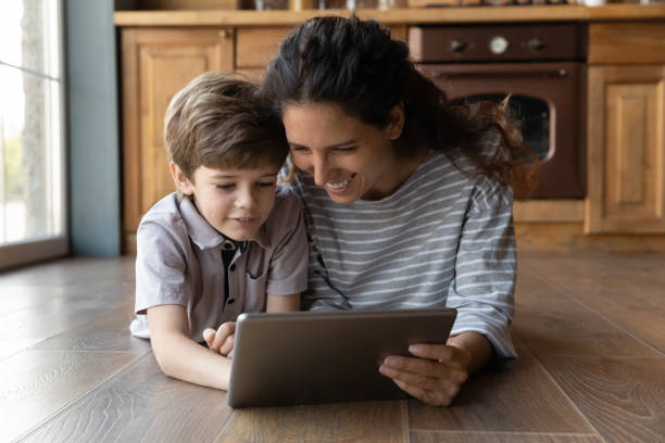 istock Happy mom have fun play on tablet with son 1300753833