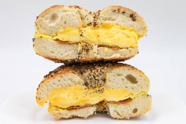 istock A Cut In Half New York Style Everything Bagel with Bacon Eggs and American Cheese on a White Plate 1300754510