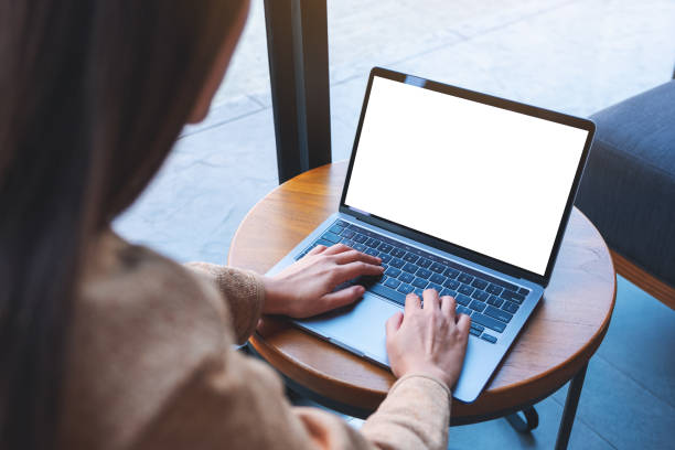istock a woman using and typing on laptop computer with blank white desktop screen in cafe 1300755520