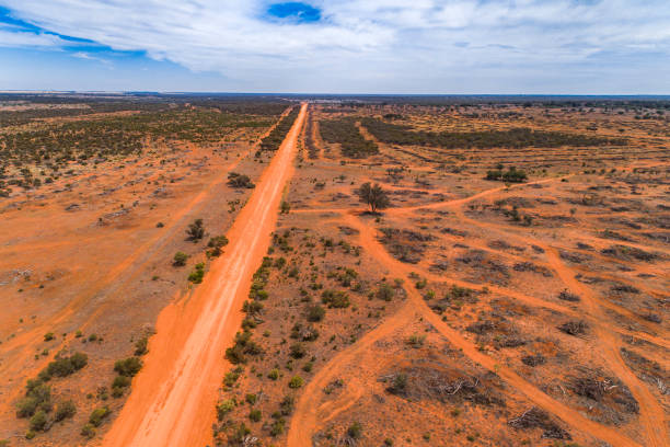 istock Straight red orange dirt road in outback Australia 1300760236