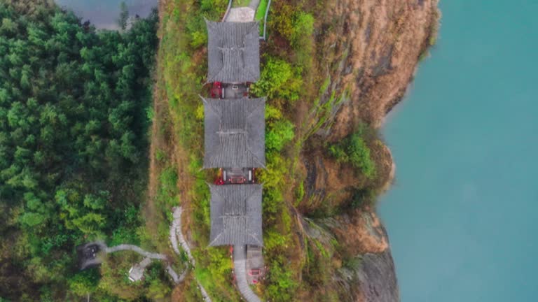 Three Taoist temples stand on the cliff island in the river