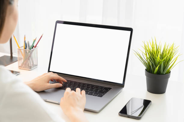 istock Woman using laptop with blank copy space screen for your advertisement. on the table in office. 1300761528